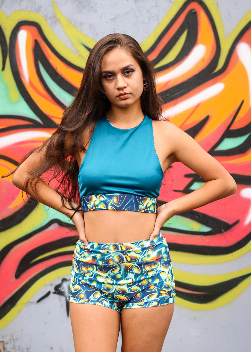 Unisex-music fesival fashion - Festival-outfit-rave-outfit - handmade-in-Brooklyn-New York City-custom made-waste conscious – psychedelic fashion – retro style – hippie fashion –handmade - Reversible X-Back Bra Top – festival top – rave top - racerback – reversable bra top - blue design - on model front view – x back bra